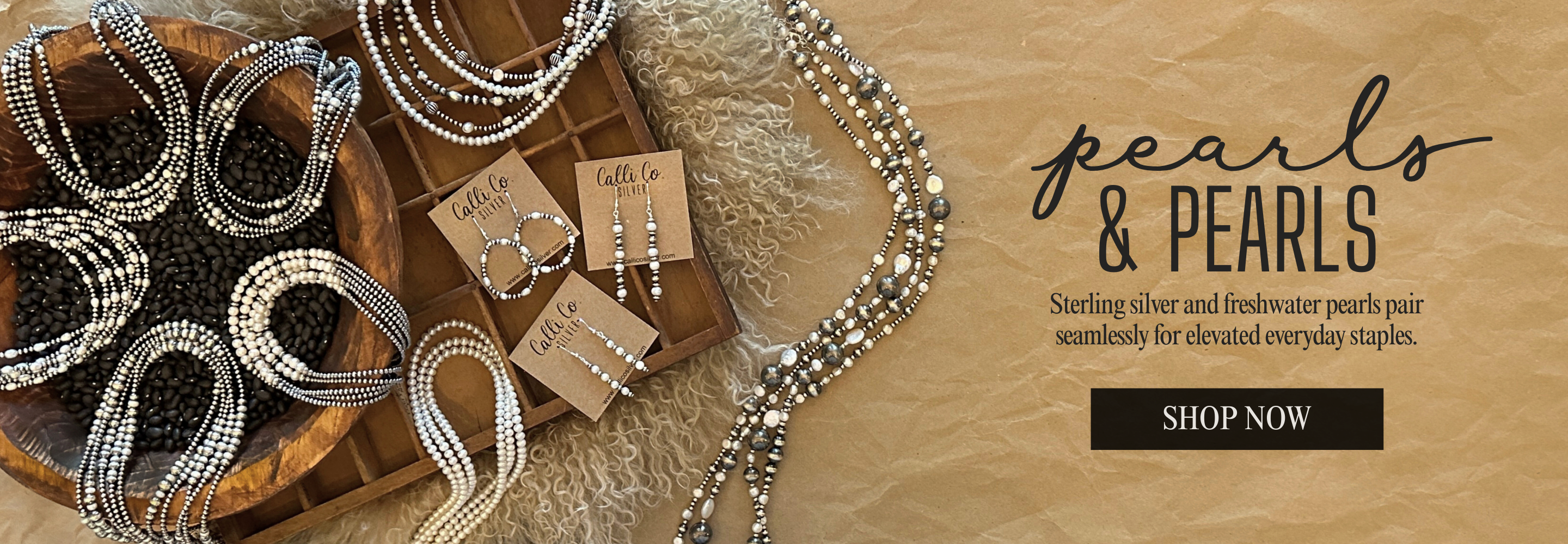 Jewelry set with pearls and silver necklaces on a wooden surface, featuring 'pears & Pearls' branding | Freshwater Pearls Collection | Calli Co Silver